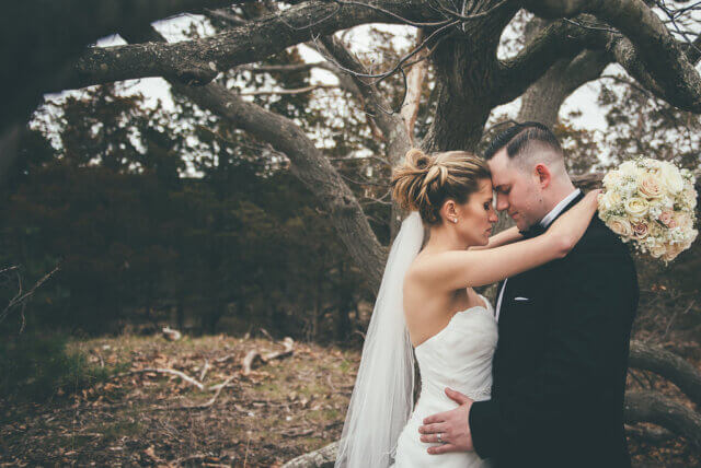 Bride and groom by a tree