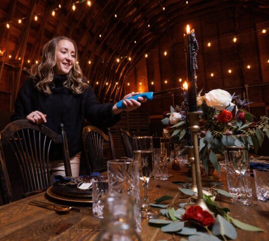 A wedding planner lights a candle
